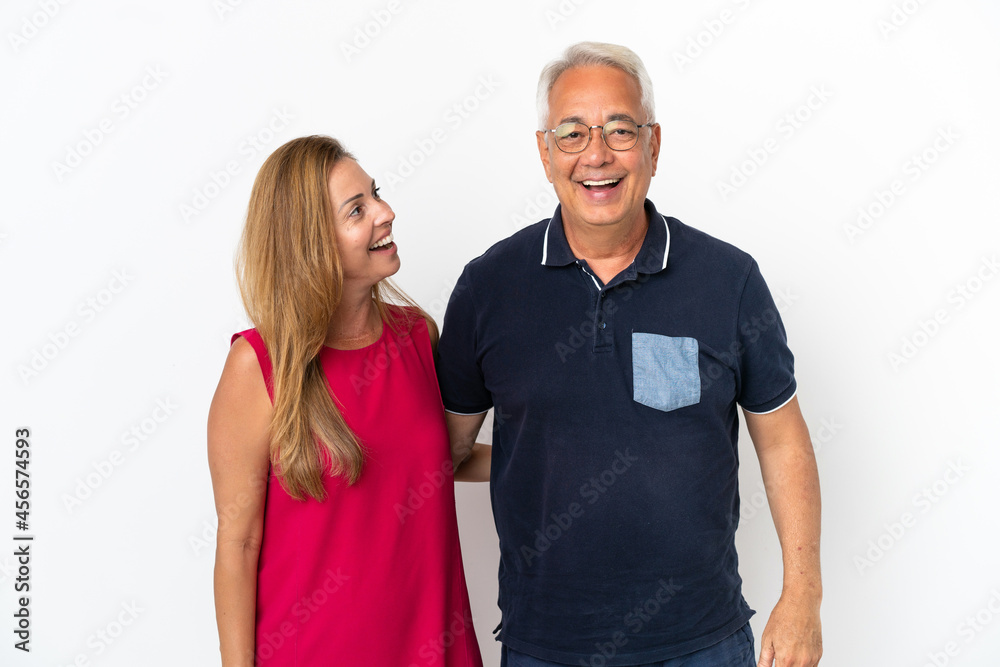 Middle age couple isolated on white background with surprise facial expression Middle age couple isolated on white background with surprise facial expression