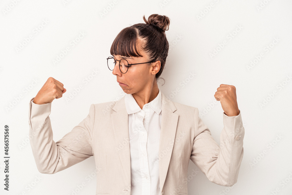 Young mixed race woman isolated on white background showing strength gesture with arms, symbol of feminine power Young mixed race woman isolated on white background showing strength gesture with arms, symbol of feminine power