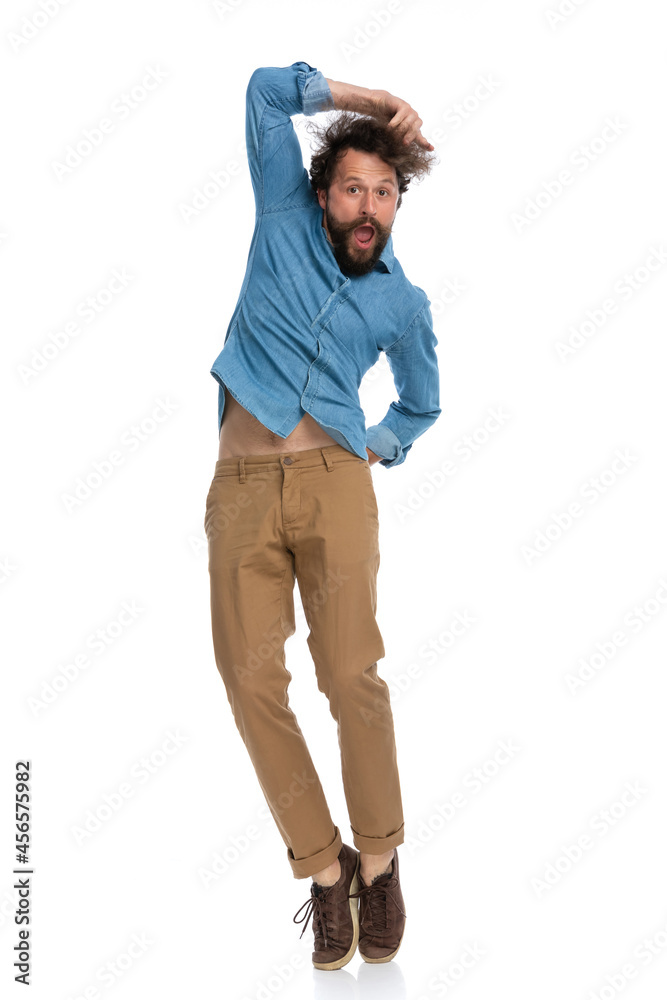 Fototapeta premium handsome casual man jumping with one hand on his head