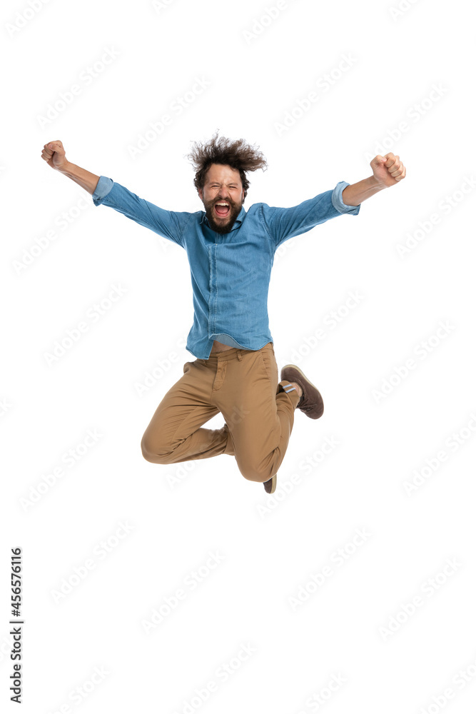 casual man jumping in the air and celebrating success