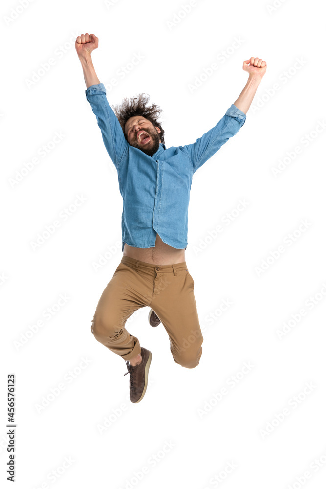 casual man full of excitement is jumping in the air casual man full of excitement is jumping in the air