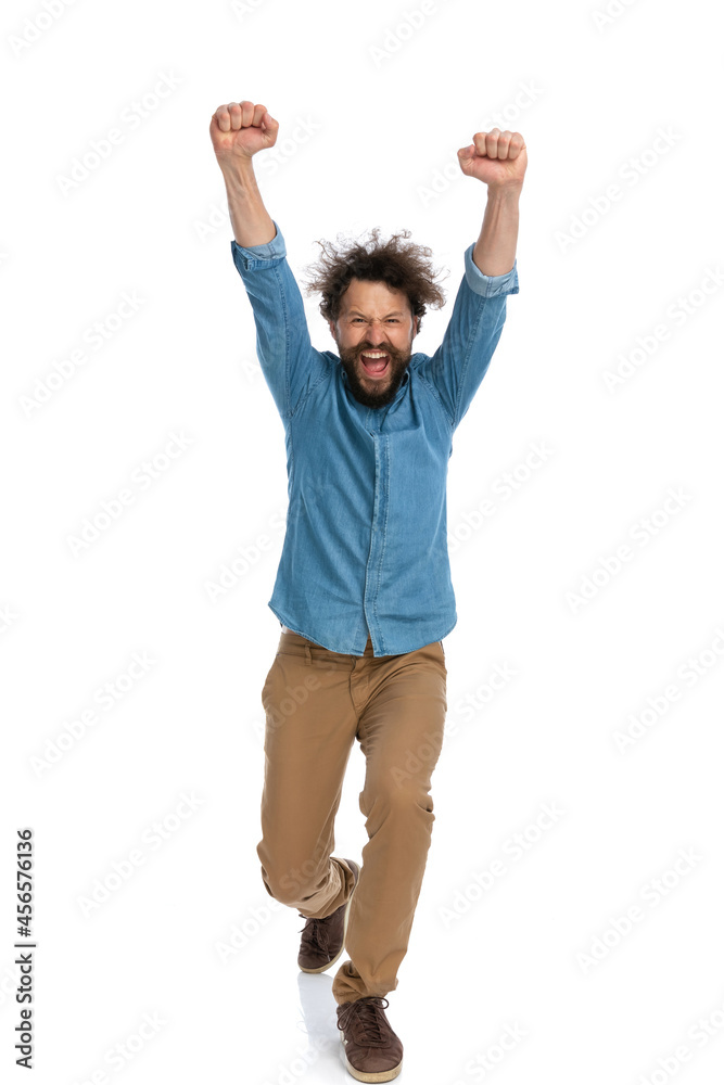 casual man walking towards the camera and celebrating the victory casual man walking towards the camera and celebrating the victory