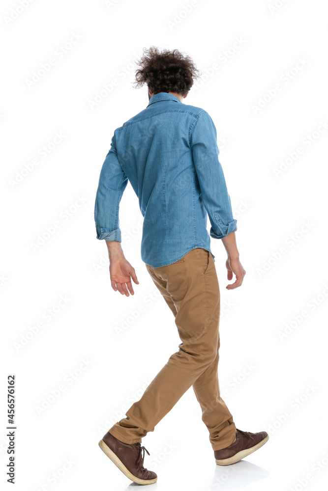 casual man walking one way and looking the other casual man walking one way and looking the other