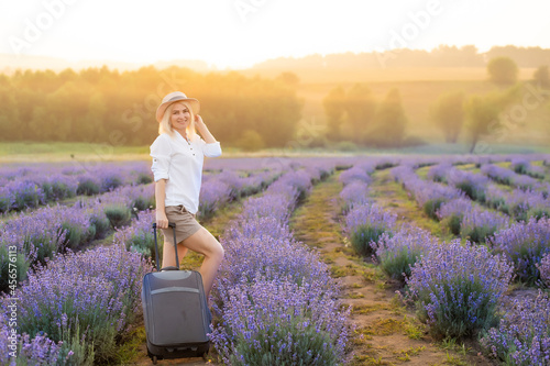 Fototapeta Naklejka Na Ścianę i Meble -  woman with bag in lavender field.