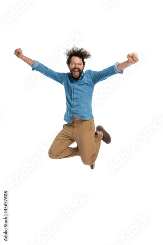 casual man jumping in the air and celebrating success