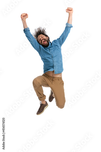 casual young man celebrating success jumping in the air © Viorel Sima