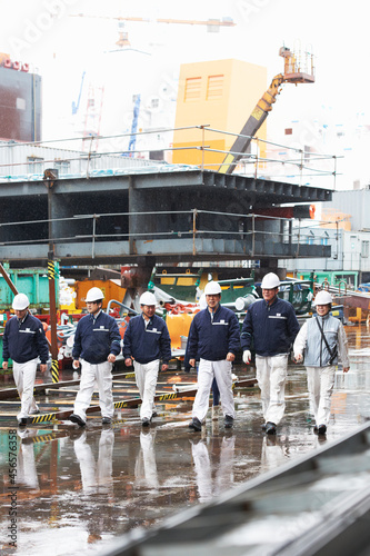 Workers walking across shipyard, GoSeong-gun, South Korea