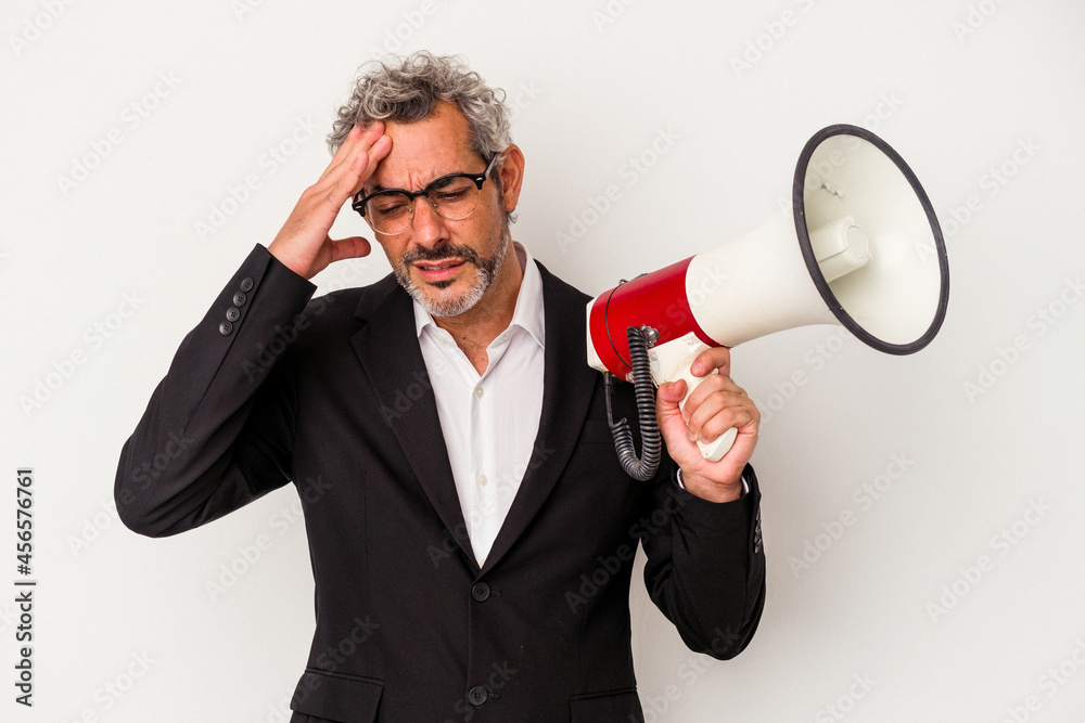 Middle age business man holding a megaphone isolated on white background being shocked, she has remembered important meeting. Middle age business man holding a megaphone isolated on white background being shocked, she has remembered important meeting.