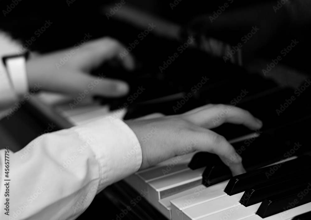 hands of a person playing the piano