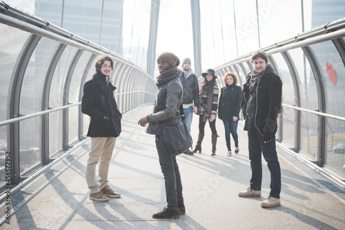 Portrait of six young adult friends on footbridge