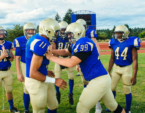Картината върху платно American football player pushing teammate