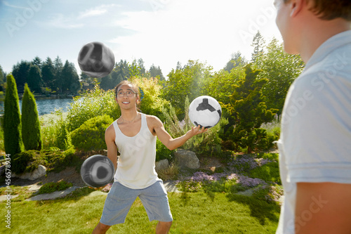 Картината върху платно Man juggling balls in field