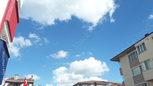 flags on the roof of a building and the blue sky.