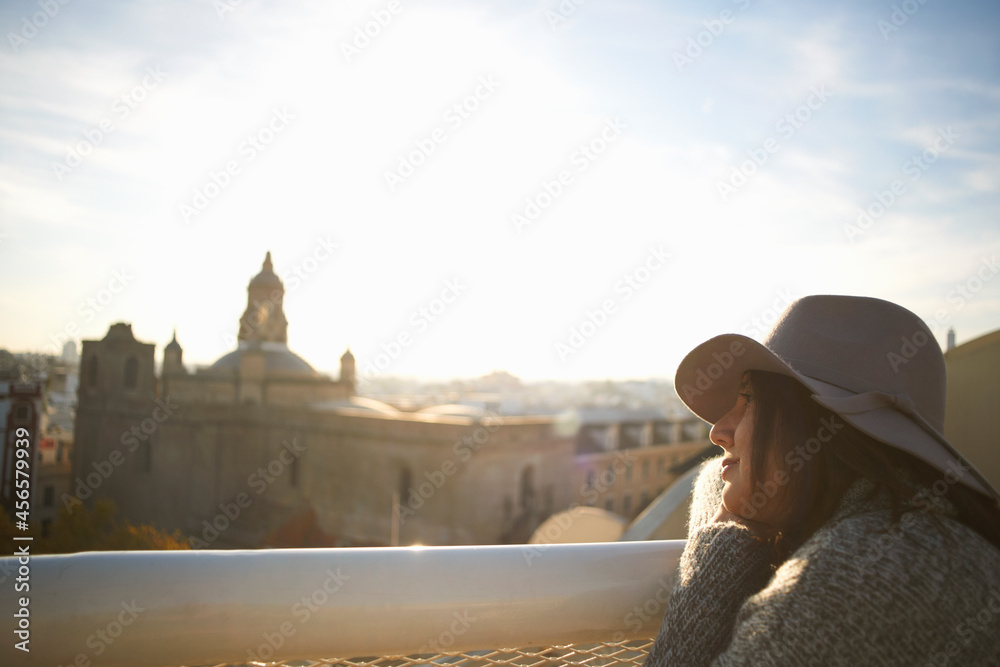 Fototapeta premium Woman enjoying view from terrace, Seville, Spain