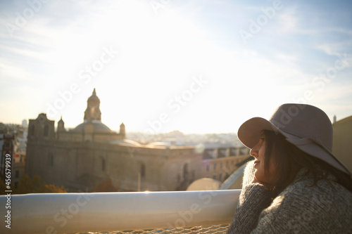 Woman enjoying view from terrace, Seville, Spain