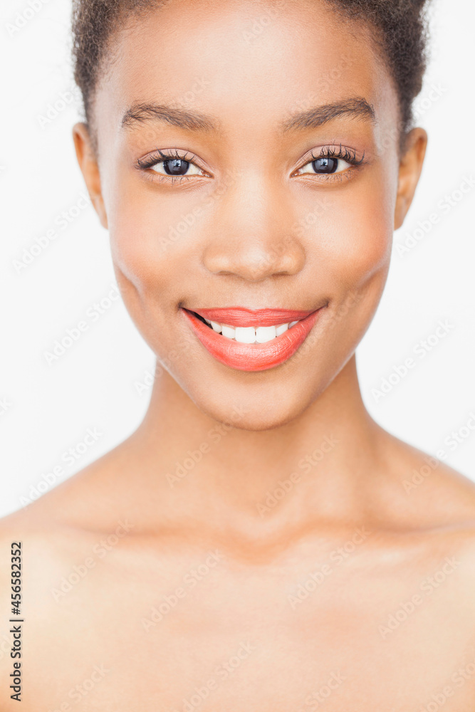 Portrait of woman wearing lipstick looking at camera smiling