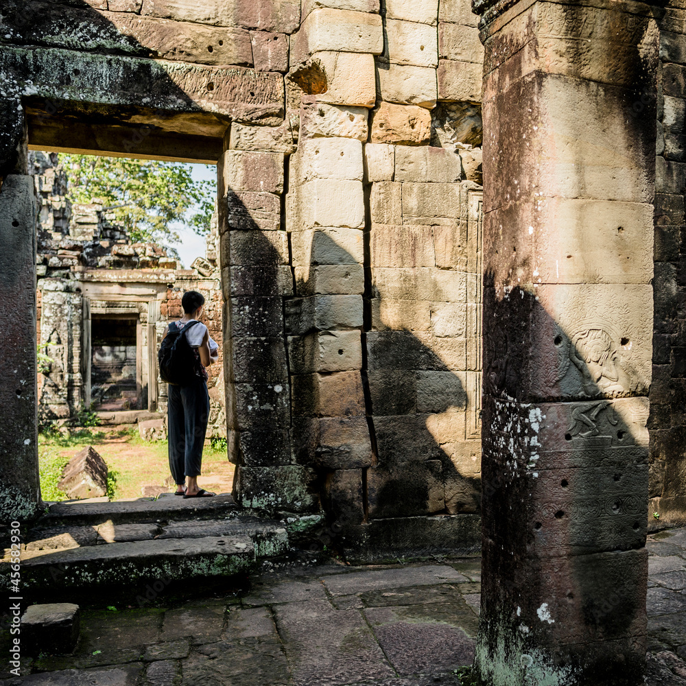 Fototapeta premium Man investigating Angkor Wat temple, Siem Reap, Cambodia