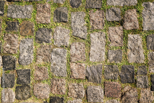 Street cobble stone pediment with dry grass top view