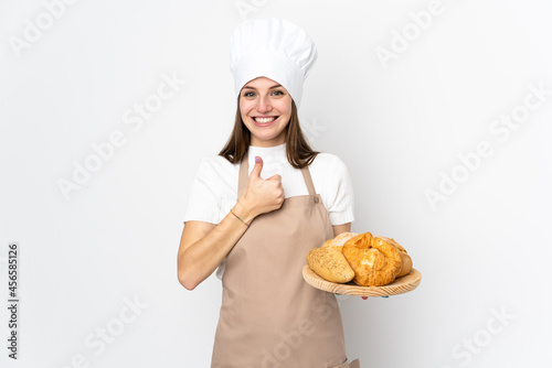 Young woman in chef uniform isolated on white background giving a thumbs up gesture