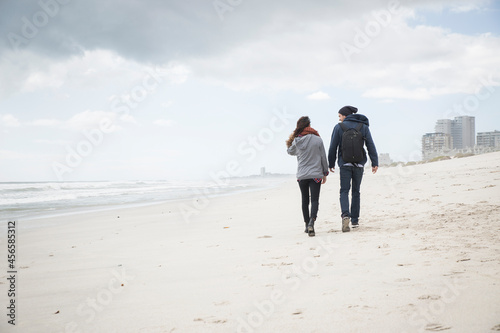 Vászonkép Rear view of young couple strolling on beach, Western Cape, South Africa
