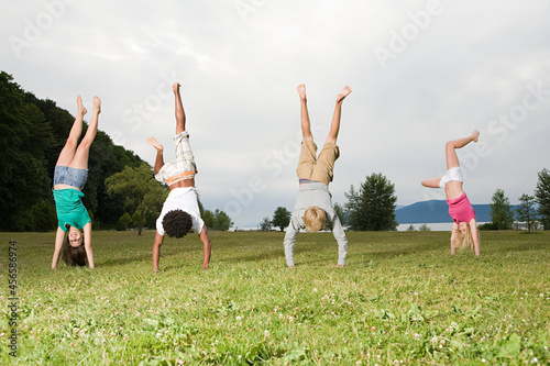Teenagers doing handstands