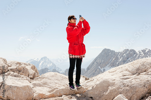 Принти на полотні Woman on top of Mount Zugspitze, Bavaria, Germany
