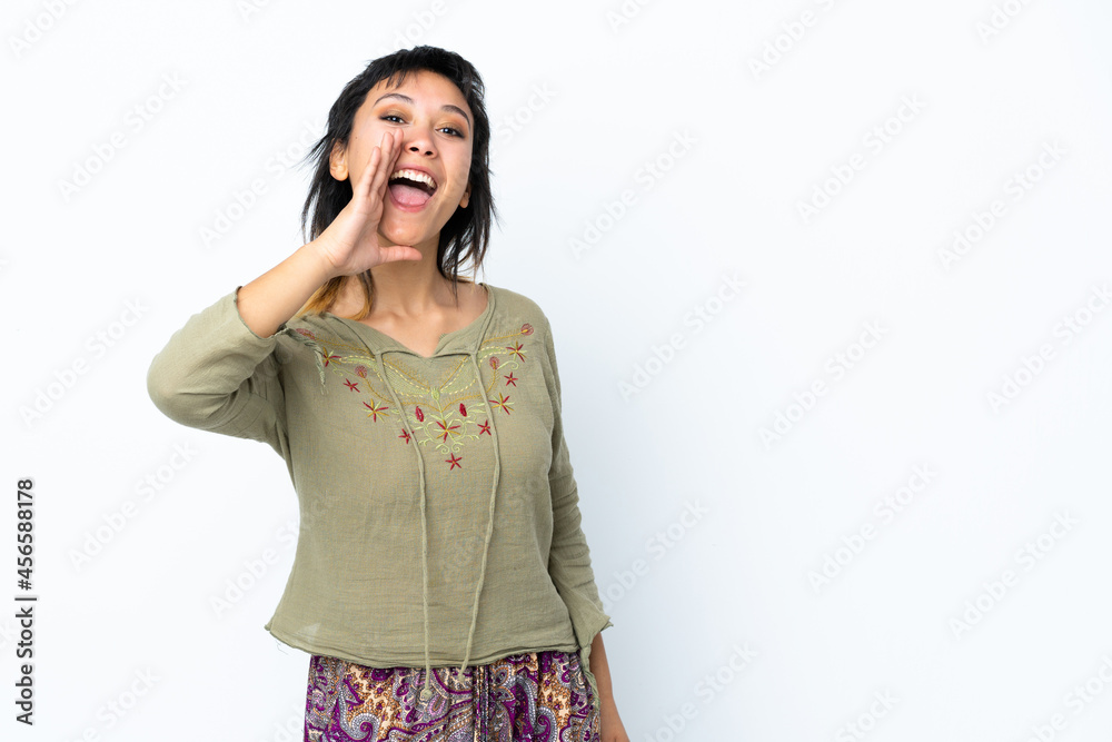 Young Uruguayan girl over isolated white background shouting with mouth wide open Young Uruguayan girl over isolated white background shouting with mouth wide open
