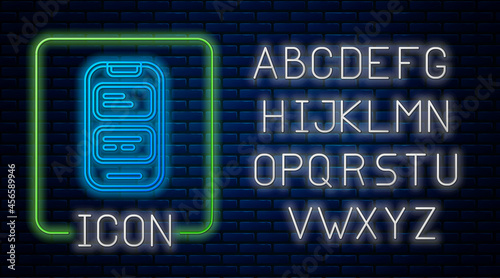 Glowing neon Online translator icon isolated on brick wall background. Foreign language conversation icons in chat speech bubble. Translating concept. Neon light alphabet. Vector