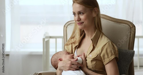 Adorable three-month-old baby drinks mothers breast milk. Young mom breastfeeding her cute infant enjoy peaceful moment of unity and care. Concept of healthcare, natural nutrition, infancy concept photo