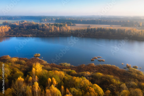 Obraz na płótnie Landscape of aerial view sunrise above the river. Yellow foliage and dry grass on bank of the river. Colorful nature in late autumn. w salonie