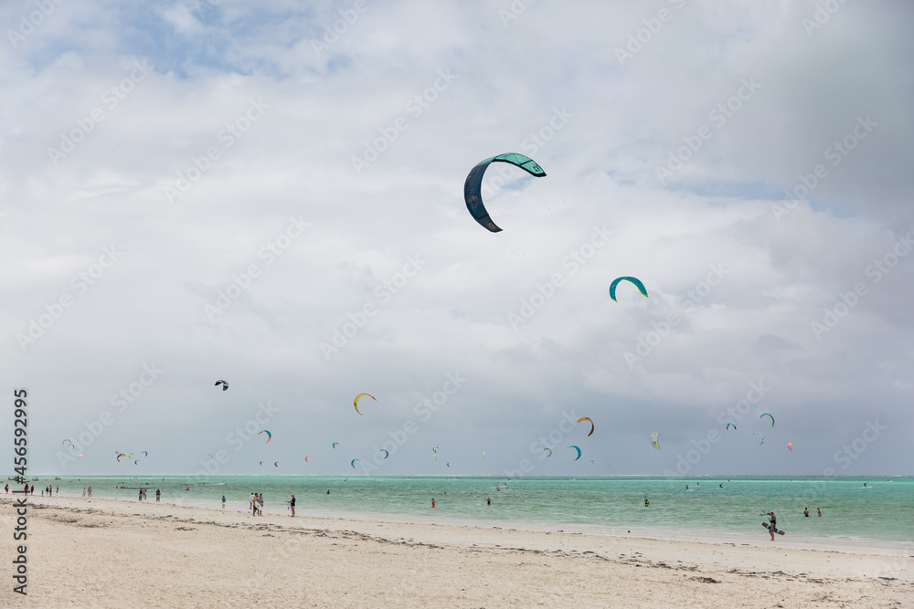 Zanzibar, Tanzania, January 22, 2021: Surfer beach, turquoise sea, many people ride surfboards and kites. Zanzibar, Tanzania, January 22, 2021: Surfer beach, turquoise sea, many people ride surfboards and kites.