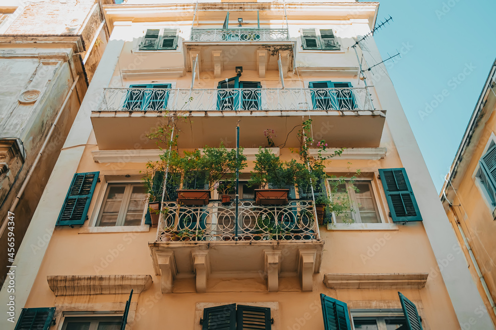 Beautiful apartment building in Italian city. Windows with shutters. Facades of old houses in narrow streets of south town. Traveling concept.