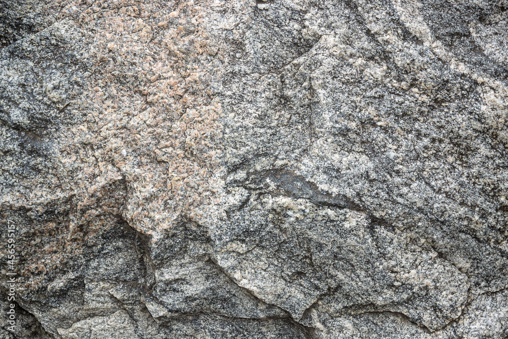Untreated natural texture of gray granite close-up. Abstract background, texture, pattern, wallpaper. Untreated natural texture of gray granite close-up. Abstract background, texture, pattern, wallpaper.