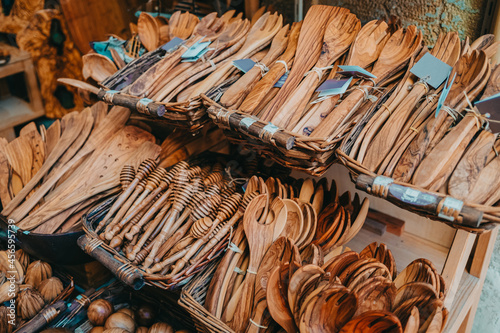 Fototapeta Naklejka Na Ścianę i Meble -  Products made from olive tree, wooden souvenirs on sale in Greece island - Corfu. Local market with craft kitchen accessories - cutting board, spoons