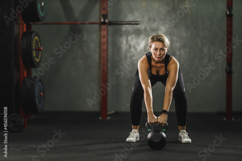 Woman Doing Training With Kettlebell At The Gym