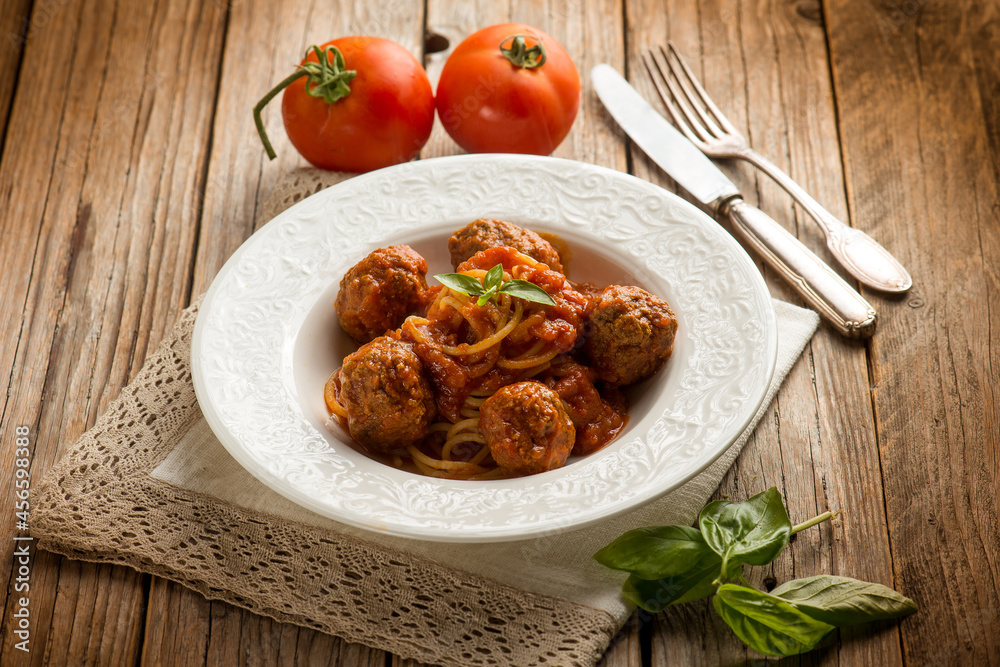 spaghetti with meatballs and tomato sauce over wooden background spaghetti with meatballs and tomato sauce over wooden background