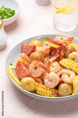 Shrimp boil heap with corn, baby potatoes, sausage and lemons.