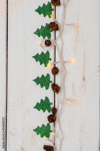 White Christmas background decorated with festive decor, lanterns, snowflakes and Christmas tree branches. Christmas greeting card. Winter holiday season. Happy New Year