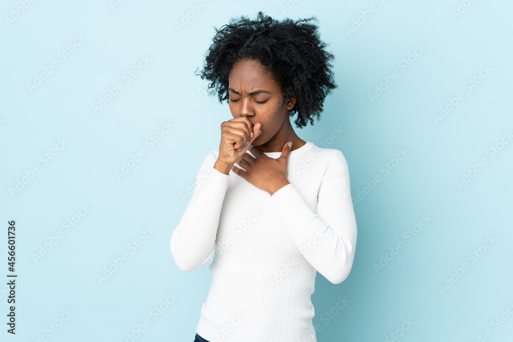 Young African American woman isolated on blue background coughing a lot Young African American woman isolated on blue background coughing a lot