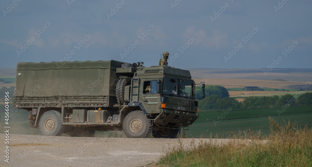British army MAN SV 4x4 army lorry logistics vehicle truck with soldier security look-out on a dirt track in action on a military exercise, Salisbury Plain UK British army MAN SV 4x4 army lorry logistics vehicle truck with soldier security look-out on a dirt track in action on a military exercise, Salisbury Plain UK