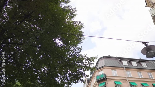 Low angle looking up point of view pov driving on car with panning the sky with city view in Sweden, driving on the road. Traveling in Europe, seeing city view from car concept