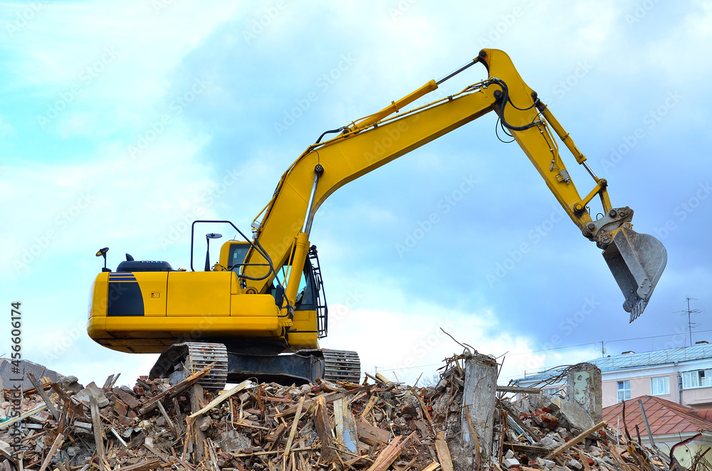 Building destruction, demolition of a building by an yellow excavator Building destruction, demolition of a building by an yellow excavator