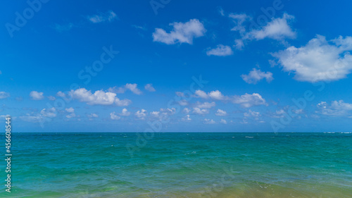 Tropical ocean views of turquoise water and blue skies with puffy clouds