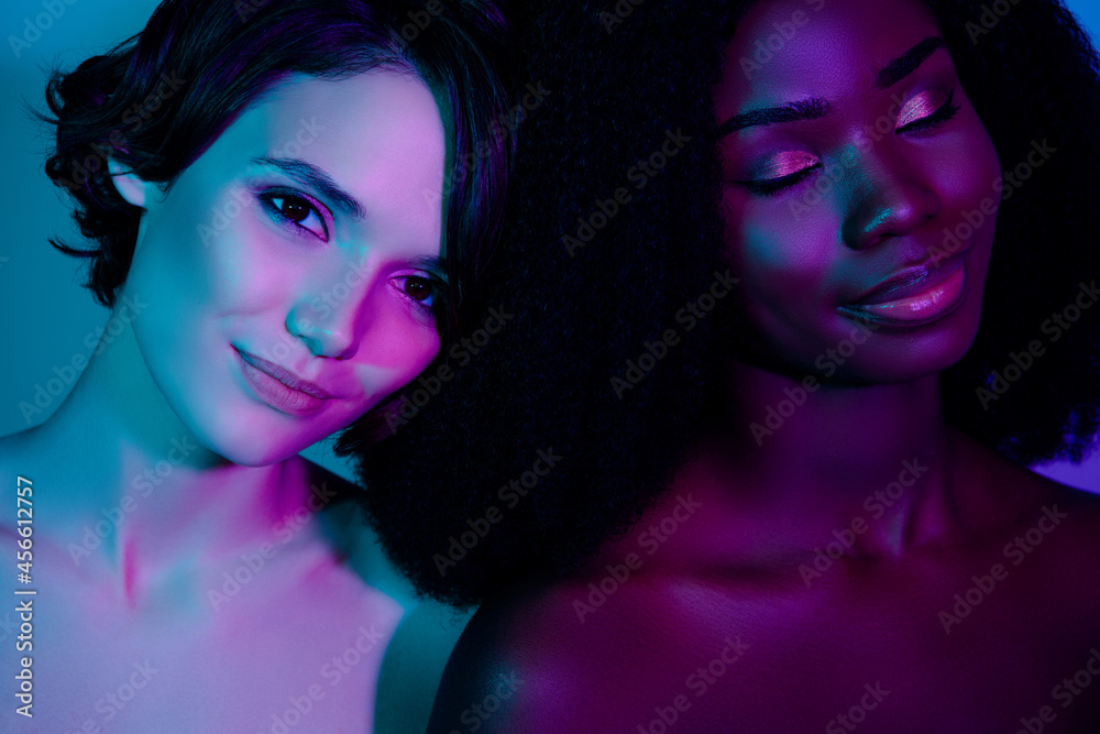 Fototapeta premium Photo of two charming positive ladies closed eyes dream perfection aesthetic isolated on neon light background