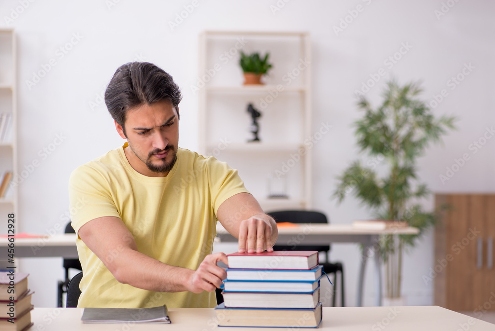 Young male student preparing for exams in the classroom Young male student preparing for exams in the classroom
