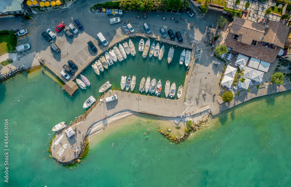 Aerial view of a small port of a Sirmione town on a shore of Garda lake in Lombardy, Italy. 
