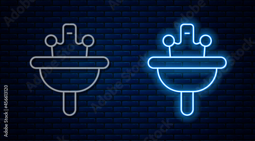 Glowing neon line Washbasin with water tap icon isolated on brick wall background. Vector