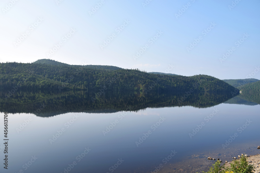 Lake Résimond, Quebec, Canada: View of perfectly still morning reflections on the lake