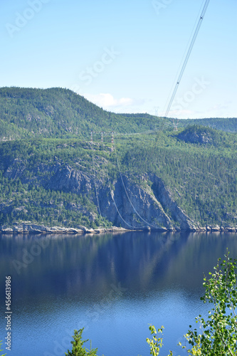 L'Anse de Tabatière, Saguenay Fjord National Park, Sepaq, Quebec, Canada: Portrait view frokm the top of the cliff looking north, with the high voltage power lines in view photo