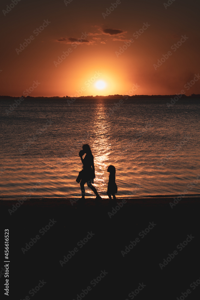 Mother, daughter and a sunset